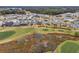 Community overview featuring houses and a golf course at 3606 Adamsville Ave, The Villages, FL 32163