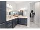 Double vanity bathroom with walk-in shower, and grey cabinets at 3606 Adamsville Ave, The Villages, FL 32163