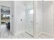 Walk-in shower with built-in seat and frameless glass enclosure at 3606 Adamsville Ave, The Villages, FL 32163