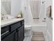Clean bathroom with tub shower combo, vanity, and neutral decor at 3606 Adamsville Ave, The Villages, FL 32163