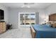 Spacious bedroom with king bed, access to patio, and large windows at 3606 Adamsville Ave, The Villages, FL 32163