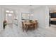 Bright dining room with wood table and chairs, hardwood floors, and access to the kitchen at 3606 Adamsville Ave, The Villages, FL 32163