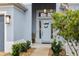 Inviting front entrance with light blue door and landscaping at 3606 Adamsville Ave, The Villages, FL 32163