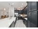 Modern kitchen with dark cabinetry, large island, and stainless steel appliances at 3606 Adamsville Ave, The Villages, FL 32163