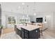 Spacious kitchen with island, stainless steel appliances, and white quartz countertops at 3606 Adamsville Ave, The Villages, FL 32163