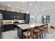 Modern kitchen with dark cabinets, quartz countertops, and stainless steel appliances at 3606 Adamsville Ave, The Villages, FL 32163