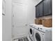 Laundry room with washer, dryer, and storage cabinets at 3606 Adamsville Ave, The Villages, FL 32163