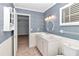 Clean bathroom with white vanity and blue patterned walls at 8850 Sw 97Th St # E, Ocala, FL 34481