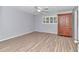 Bright bedroom featuring light grey walls and wood-look flooring at 8850 Sw 97Th St # E, Ocala, FL 34481