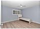 Light grey bedroom with wood flooring, a ceiling fan, and a single bed at 8850 Sw 97Th St # E, Ocala, FL 34481