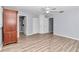 Bright bedroom with wood-look floors, a ceiling fan, and plenty of closet space at 8850 Sw 97Th St # E, Ocala, FL 34481