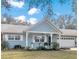 Charming light blue house with a landscaped yard and attached garage at 8850 Sw 97Th St # E, Ocala, FL 34481