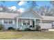 Charming light blue house with a covered porch and two-car garage at 8850 Sw 97Th St # E, Ocala, FL 34481