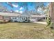 House exterior showing front yard landscaping and a partial view of neighboring homes at 8850 Sw 97Th St # E, Ocala, FL 34481