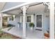 Inviting front porch with hanging plants and classic columns at 8850 Sw 97Th St # E, Ocala, FL 34481