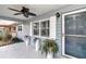 Covered porch with light blue walls, ceiling fan, and potted plants at 8850 Sw 97Th St # E, Ocala, FL 34481