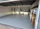 Spacious garage with painted floor and plenty of room for parking and storage at 8850 Sw 97Th St # E, Ocala, FL 34481