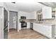 Modern kitchen featuring white cabinets, stainless steel appliances, and updated countertops at 8850 Sw 97Th St # E, Ocala, FL 34481