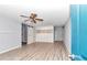 Main bedroom with wood flooring, ceiling fan, and white built-in cabinets at 8850 Sw 97Th St # E, Ocala, FL 34481