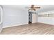 Large bedroom with wood flooring, ceiling fan and built in shelving at 8850 Sw 97Th St # E, Ocala, FL 34481