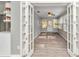 Cozy sunroom with wood-look floors, natural light, and views of the outdoor landscape at 8850 Sw 97Th St # E, Ocala, FL 34481
