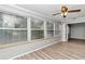 Sunroom with wood floors, plenty of natural light, and view of the backyard at 8850 Sw 97Th St # E, Ocala, FL 34481