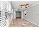 Sunroom with light grey walls, wood flooring, and multiple windows at 8850 Sw 97Th St # E, Ocala, FL 34481