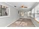 Sunroom with light grey walls, wood flooring, and multiple windows at 8850 Sw 97Th St # E, Ocala, FL 34481