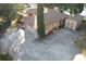 Aerial view of house with large driveway, shed, mature landscaping, and proximity to a lake at 9835 Lakeshore Dr, Clermont, FL 34711