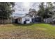 View of home exterior with pool and grassy backyard at 1001 Michelle Ct, Tavares, FL 32778