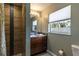 Updated bathroom with tiled walk-in shower, vanity, and window at 1001 Michelle Ct, Tavares, FL 32778
