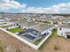 Aerial view of house and community with pool and fence at 1115 Calico Pointe Cir, Groveland, FL 34736