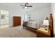 Cozy bedroom with dresser, nightstand and ensuite bathroom at 1115 Calico Pointe Cir, Groveland, FL 34736