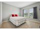 Spacious bedroom with queen bed and two windows at 1115 Calico Pointe Cir, Groveland, FL 34736