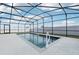 Relaxing screened pool with waterfall feature and deck at 1115 Calico Pointe Cir, Groveland, FL 34736
