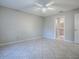 Large bedroom showing neutral walls, tile floors, and ensuite bathroom access at 1320 Arredondo Dr, The Villages, FL 32162