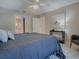 Bedroom with ceiling fan, calming decor, bathroom access and a comfortable chair, perfect for relaxation at 1320 Arredondo Dr, The Villages, FL 32162