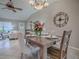 Cozy dining room features a rustic table, chandelier, and views of the living area at 1320 Arredondo Dr, The Villages, FL 32162