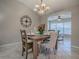Elegant dining room with stylish table setting, chandelier, and open view to living area at 1320 Arredondo Dr, The Villages, FL 32162