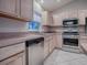 Modern kitchen with stainless steel appliances, light wood cabinets, and spacious countertops at 1320 Arredondo Dr, The Villages, FL 32162
