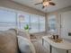 Bright living room with tile floors and large windows offering views of backyard with a swing set at 1320 Arredondo Dr, The Villages, FL 32162