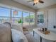Bright living room with tile floors and large windows offering views of backyard with a swing set at 1320 Arredondo Dr, The Villages, FL 32162