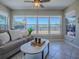 Bright living room with tile floors and large windows offering scenic views of pasture at 1320 Arredondo Dr, The Villages, FL 32162