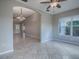 Spacious living room with tile floors, bright window and chandelier view into dining room at 1320 Arredondo Dr, The Villages, FL 32162