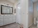 Bright bathroom with white vanity, large mirror, and tile floor at 1710 Hilton Head Blvd, The Villages, FL 32159