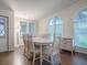 Spacious dining area with an oval table, sideboard and hardwood floors at 1710 Hilton Head Blvd, The Villages, FL 32159