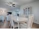 Bright dining room with an oval table and charming white chairs at 1710 Hilton Head Blvd, The Villages, FL 32159