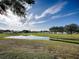 Peaceful view of a golf course with a pond at 1710 Hilton Head Blvd, The Villages, FL 32159