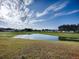 Serene view of the golf course and pond at 1710 Hilton Head Blvd, The Villages, FL 32159