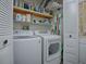 Laundry room with washer, dryer, and storage shelves at 1710 Hilton Head Blvd, The Villages, FL 32159